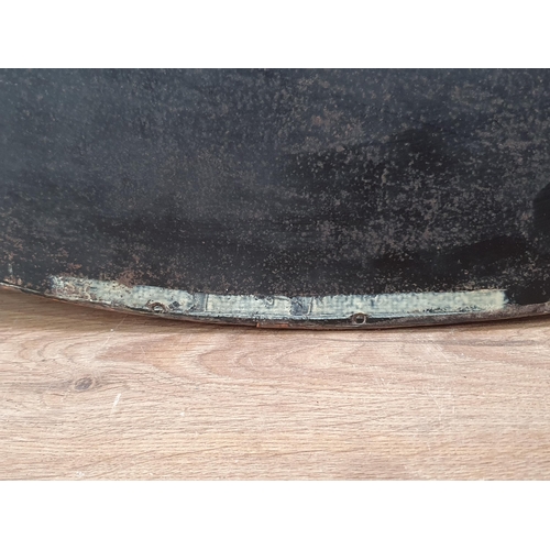 24 - An oval copper framed Wall Mirror with applied shell type roundel decorations with bevelled plate, b... 