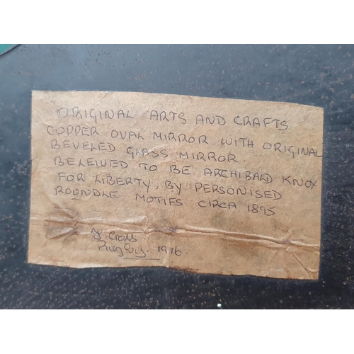 24 - An oval copper framed Wall Mirror with applied shell type roundel decorations with bevelled plate, b... 