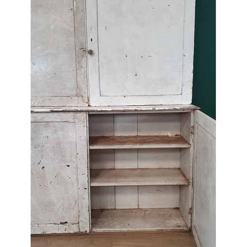 25 - A white painted pine two piece Pantry Cupboard, the top with moulded cornice above pair of panelled ... 