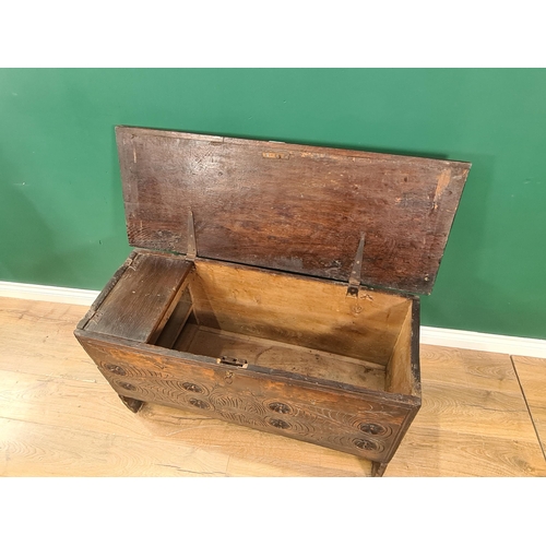 30 - A 17th century carved elm chest with molded oak panel top above carved rosette panel front, with int... 