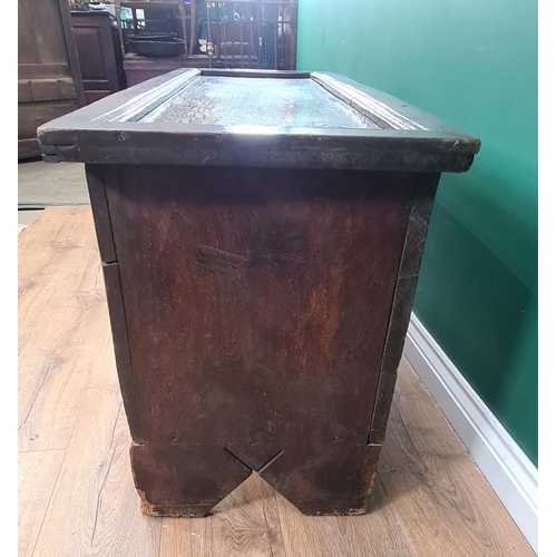 30 - A 17th century carved elm chest with molded oak panel top above carved rosette panel front, with int... 