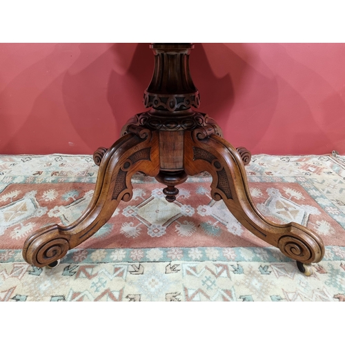 32 - A Victorian walnut Centre Table with shaped top raised on quadruple base with scroll feet 4ft 10in W... 