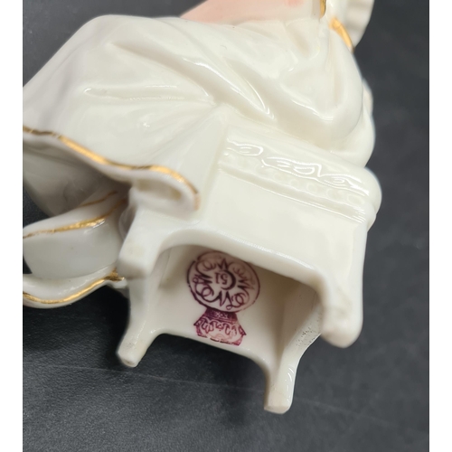 51 - A pair of Continental porcelain Seated Figures wit painted details, 3in,blue crowned N, another Figu... 