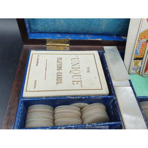 53 - A 19th century rosewood Games Box with mother of pearl inlay to the lid depicting playing cards, con... 