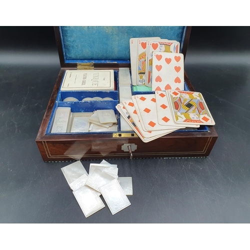 53 - A 19th century rosewood Games Box with mother of pearl inlay to the lid depicting playing cards, con... 