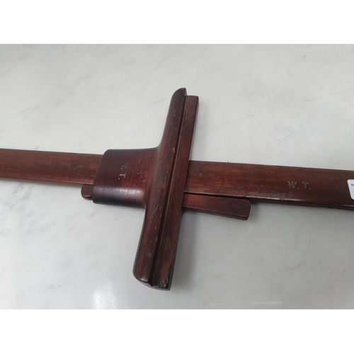 56 - A Carpenter's mahogany adjustable T Bar/Clamp with brass mount for pin, and engraved initials W.T (R... 
