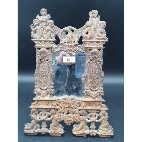 66 - A cast iron framed Mirror with cherub, eagle and trophy surround, 14 x 10in (R1)