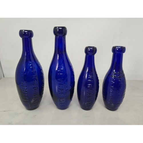 68 - Four flat bottomed blue glass Aerated Water Bottles of torpedo shape by Bradford Bros, etc, Newcastl... 
