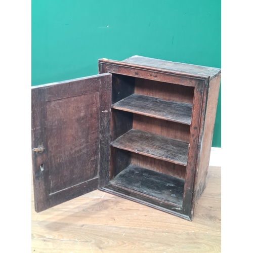 7 - An antique oak Hanging Cupboard with moulded frame, single fitted panel door enclosing two fitted sh... 