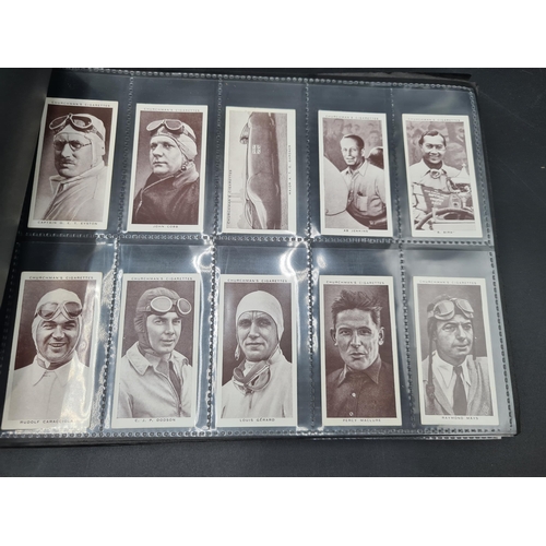 96 - A green Album containing Sets of Cigarette Cards including dogs, birds, historians, paintings, kings... 