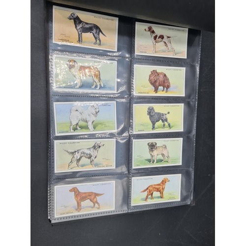 96 - A green Album containing Sets of Cigarette Cards including dogs, birds, historians, paintings, kings... 