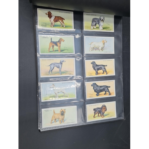 96 - A green Album containing Sets of Cigarette Cards including dogs, birds, historians, paintings, kings... 