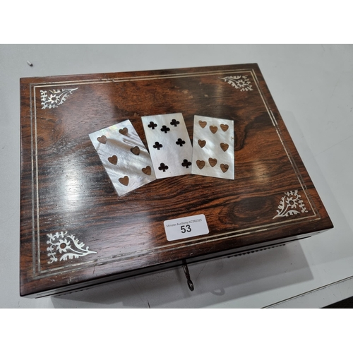 53 - A 19th century rosewood Games Box with mother of pearl inlay to the lid depicting playing cards, con... 
