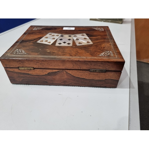 53 - A 19th century rosewood Games Box with mother of pearl inlay to the lid depicting playing cards, con... 