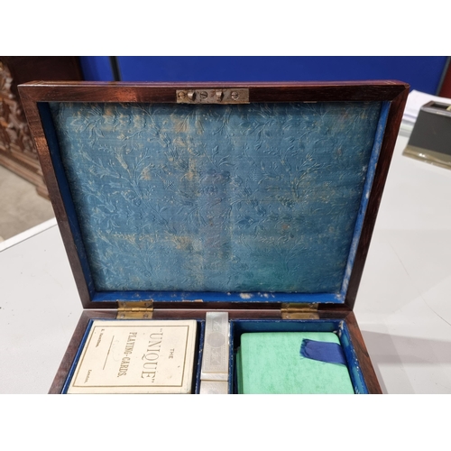 53 - A 19th century rosewood Games Box with mother of pearl inlay to the lid depicting playing cards, con... 