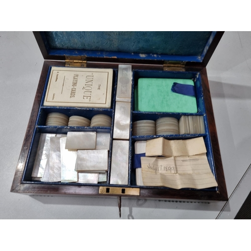 53 - A 19th century rosewood Games Box with mother of pearl inlay to the lid depicting playing cards, con... 