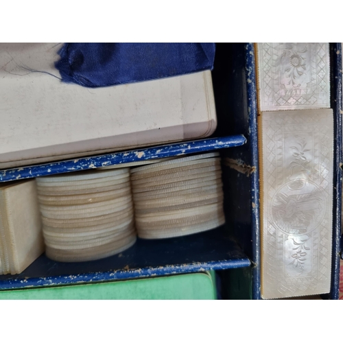 53 - A 19th century rosewood Games Box with mother of pearl inlay to the lid depicting playing cards, con... 