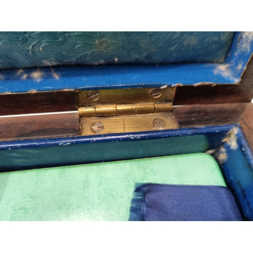 53 - A 19th century rosewood Games Box with mother of pearl inlay to the lid depicting playing cards, con... 