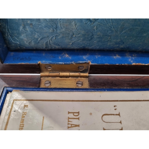 53 - A 19th century rosewood Games Box with mother of pearl inlay to the lid depicting playing cards, con... 