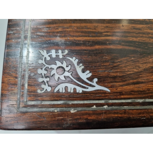 53 - A 19th century rosewood Games Box with mother of pearl inlay to the lid depicting playing cards, con... 