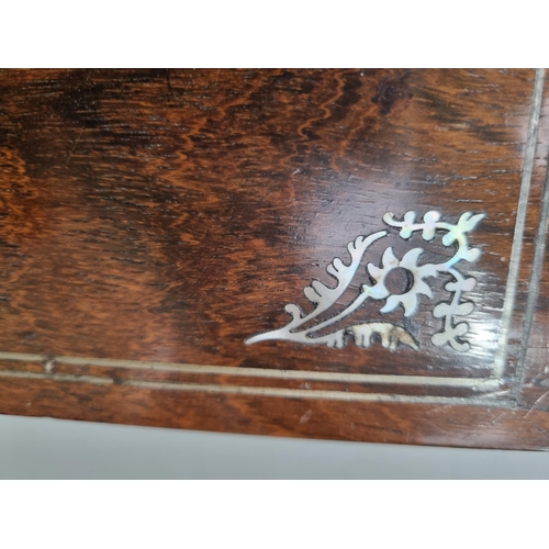 53 - A 19th century rosewood Games Box with mother of pearl inlay to the lid depicting playing cards, con... 