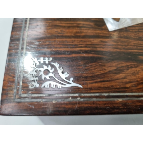53 - A 19th century rosewood Games Box with mother of pearl inlay to the lid depicting playing cards, con... 