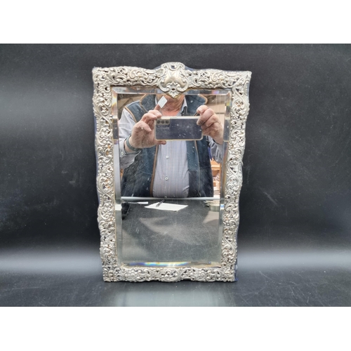 130 - A Victorian silver framed Easel Mirror with scroll embossing and piercing, Birmingham 1898, 14 x 9in