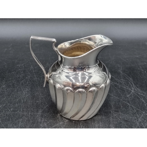 142 - An Edwardian silver Jug with spiral gadroon embossing, marks worn, circa 1905