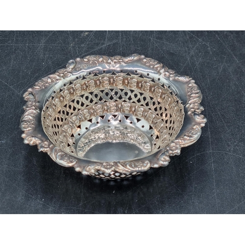 144 - An Edward VII silver pierced circular Bonbon Dish with floral and scroll embossing, Birmingham 1904