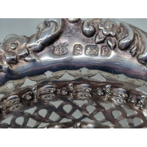 144 - An Edward VII silver pierced circular Bonbon Dish with floral and scroll embossing, Birmingham 1904