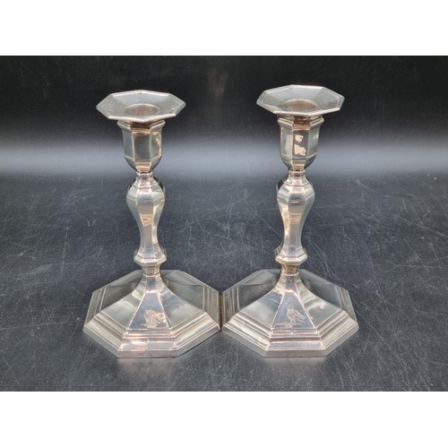 146 - A pair of Victorian silver Candlesticks with baluster stems on octagonal bases engraved eagle crests... 