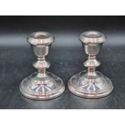 147 - A pair of Elizabeth II silver Candlesticks on reeded circular bases, Birmingham 1971, 5in
