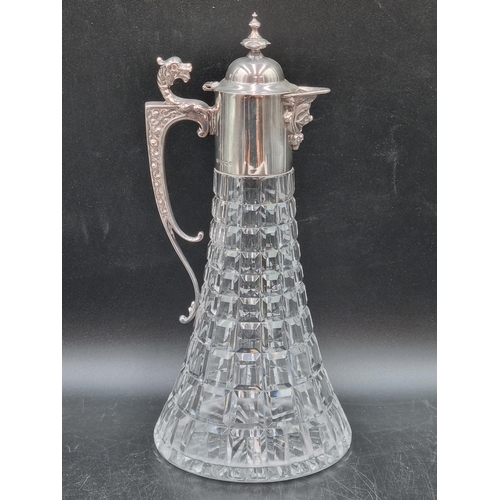 149 - An Elizabeth II silver mounted glass Claret Jug with ornate spout, griffin handle, Sheffield 1973, m... 