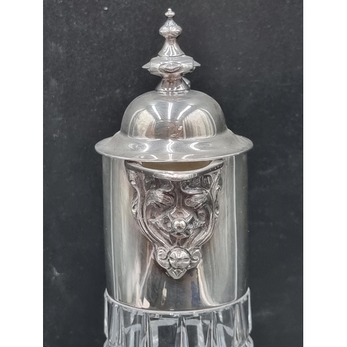 149 - An Elizabeth II silver mounted glass Claret Jug with ornate spout, griffin handle, Sheffield 1973, m... 