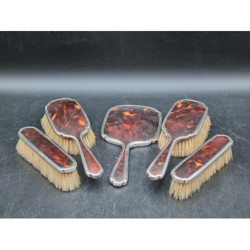153 - A George V silver and tortoiseshell mounted five piece Dressing Table Set, London 1929