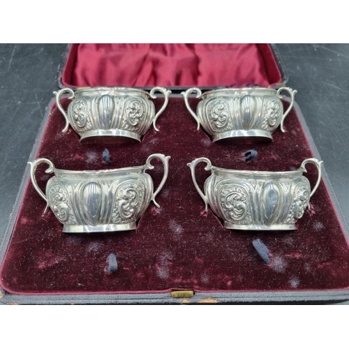156 - A Set of four Victorian silver oval two handled Salts with scroll embossing, Birmingham 1899, in cas... 