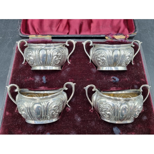 156 - A Set of four Victorian silver oval two handled Salts with scroll embossing, Birmingham 1899, in cas... 