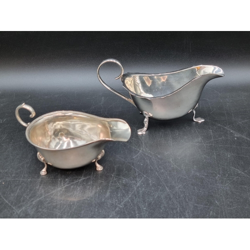 165 - A George V silver Sauce Boat with scroll handle  on hoof feet, Birmingham 1929, and another, Birming... 
