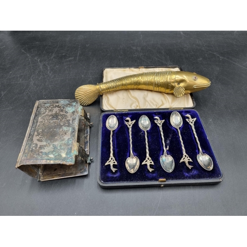 175 - A Niello style Book Cover with scroll decoration and hinged clasps, A/F, an articulated brass Fish w... 
