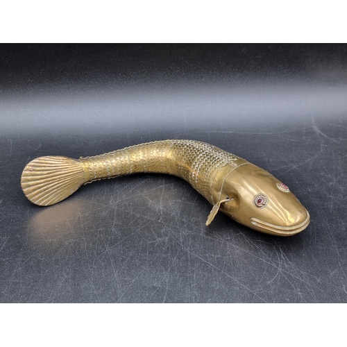 175 - A Niello style Book Cover with scroll decoration and hinged clasps, A/F, an articulated brass Fish w... 
