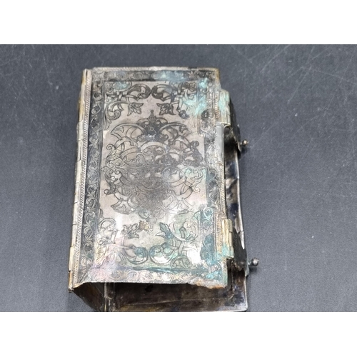 175 - A Niello style Book Cover with scroll decoration and hinged clasps, A/F, an articulated brass Fish w... 