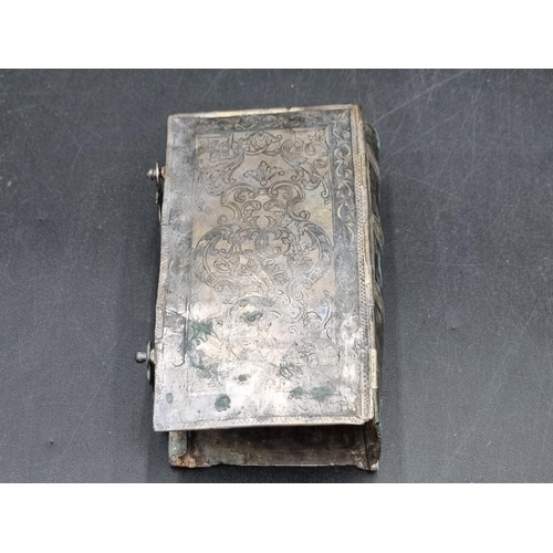 175 - A Niello style Book Cover with scroll decoration and hinged clasps, A/F, an articulated brass Fish w... 
