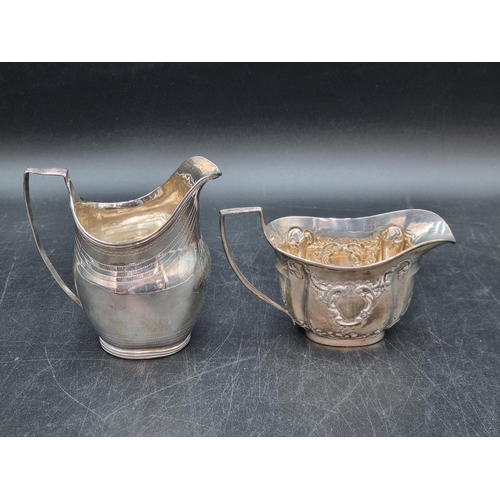 176 - A George III silver oval Milk Jug with engraved friezes and initials, London 1809, A/F, and an Edwar... 