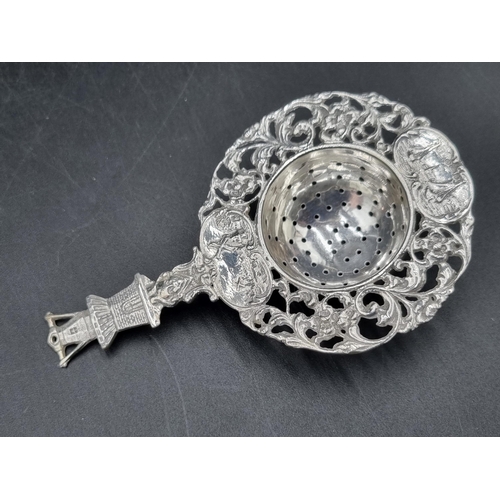 178 - A Dutch style Tea Strainer with windmill finial, on plated stand, and a small silver Trophy