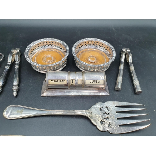 197 - A silver mounted Brush, a plated cased Calendar, pair of Bottle Coasters, Stilton Scoop, Pickle Fork... 