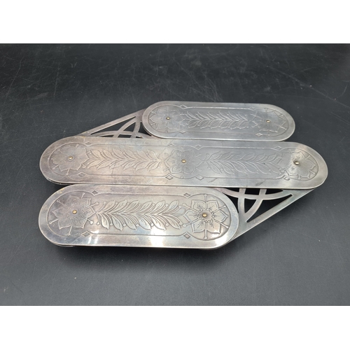 206 - An unusual silver plated Extending Table Coaster with floral and leafage decoration on seven swivel ... 