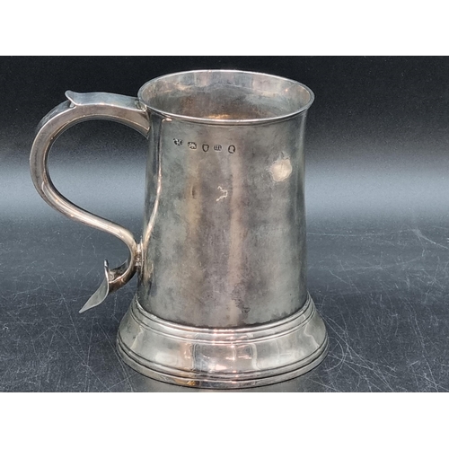 212 - A George III silver Pint Mug having scroll handle with heart shape finial, engraved initials S over ... 