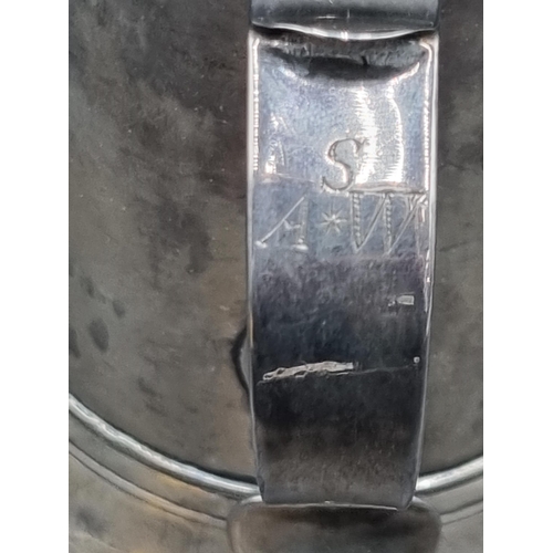 212 - A George III silver Pint Mug having scroll handle with heart shape finial, engraved initials S over ... 