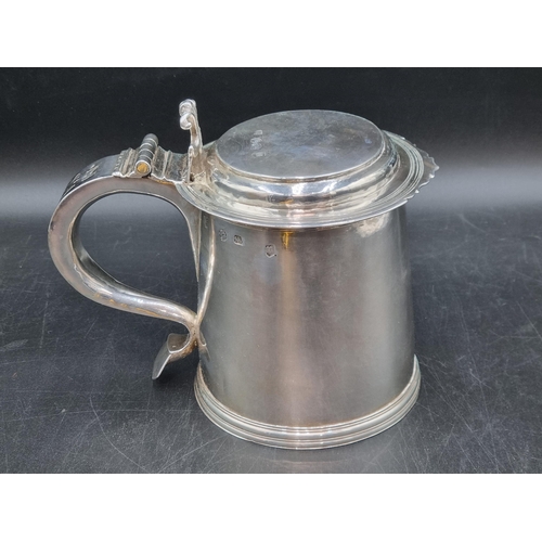 216 - A William & Mary silver Tankard with flat cover, vollute thumb piece, scroll handle engraved initial... 