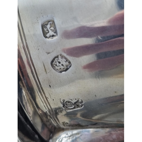 216 - A William & Mary silver Tankard with flat cover, vollute thumb piece, scroll handle engraved initial... 